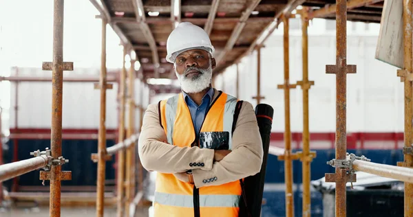 Construction, building and mature architect with design, vision and idea for development while working at a construction site. Portrait of elderly industrial worker with arms crossed for architecture.