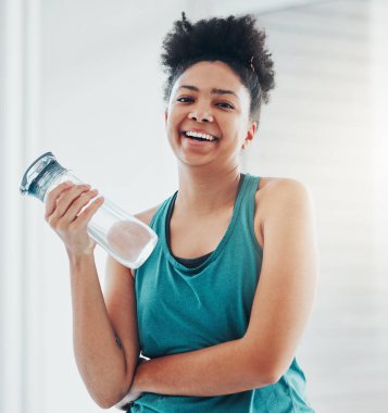 Portrait, fitness and water with a sports black woman staying hydrated during her cardio or endurance workout. Exercise, training and wellness with a female athlete holding a bottle for hydration. clipart