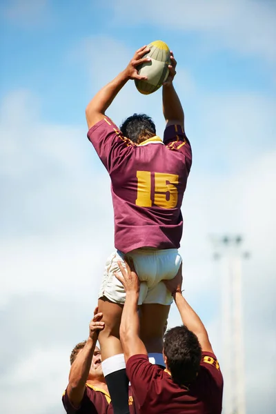 Caught Mid Game Rearview Shot Young Rugby Player Catching Ball — Stok fotoğraf