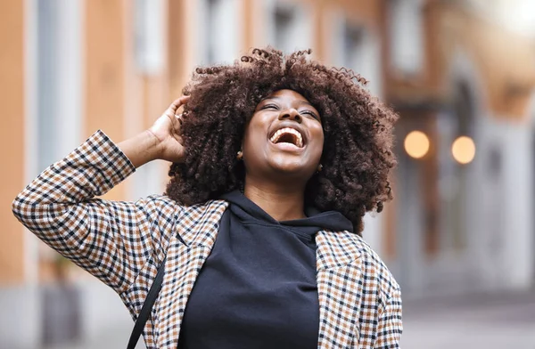 Black woman, laughing and afro hair in city fun, goofy or silly travel in urban New York or holiday location. Smile, happy or comic student in fashion, trendy or cool clothes with natural hairstyle.