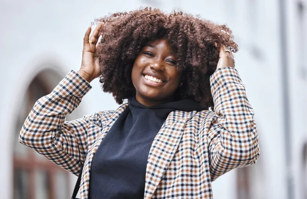 Black woman, portrait and afro hair in city fun, goofy or silly travel in urban New York or holiday location. Smile, happy or playful student in fashion, trendy or cool clothes with natural hairstyle.