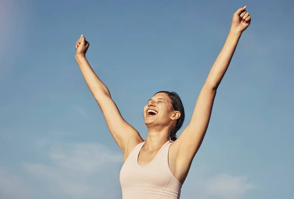 Fitness success, workout and woman arms in air for workout achievement outdoor. Excited, smile and athlete with blue sky feeling freedom from motivation and happiness with exercise target goal.