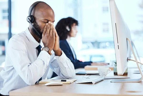 Business, black man and stress in call center, headache and depression with telemarketing, burnout and tired. Corporate, African American male agent or consultant with computer, overworked or anxiety.