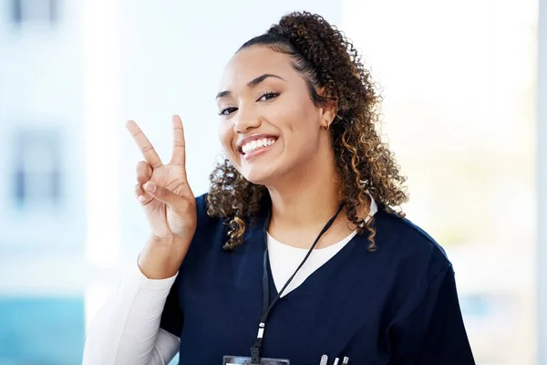 Doctor, portrait and peace sign hands in hospital wellness, medicine trust or medical support of life insurance, help or vote. Smile, happy and nurse with number gesture in healthcare or woman emoji.