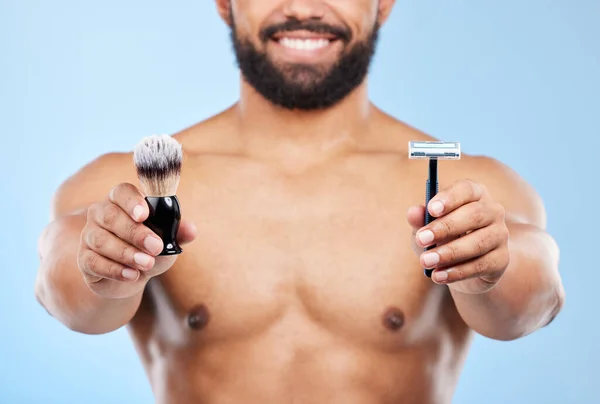 Everything you need for a smooth shave. Studio shot of an unrecognizable man shaving against a blue background