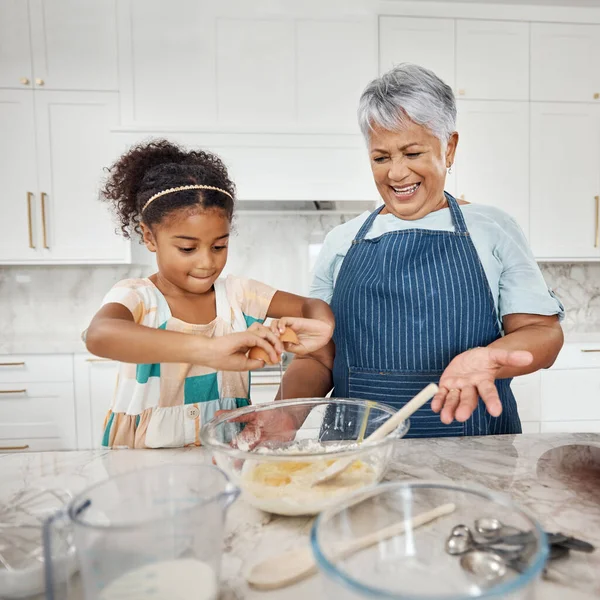 Learning, cooking grandmother and girl with egg and flour in bowl in home kitchen. Education, family care and happy grandma teaching child how to bake, bonding and enjoying baking time together