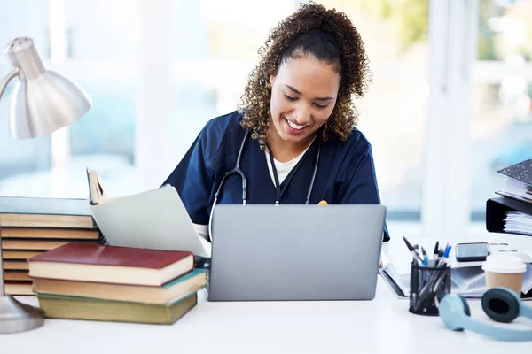 Woman, laptop or medical student books for research, education studying or college learning in university hospital. Smile, happy or healthcare nurse with technology in scholarship medicine internship.