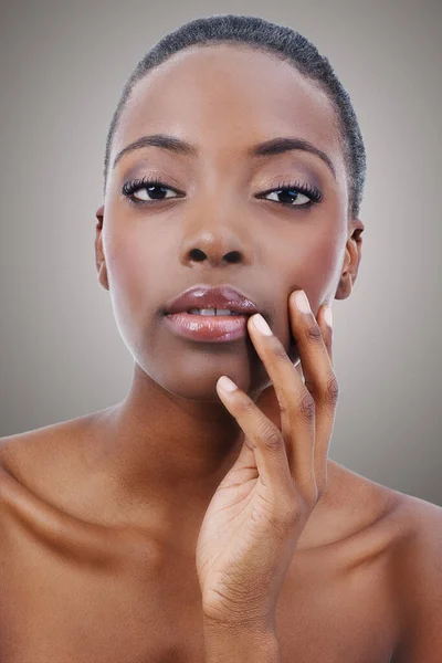 Smooth and soft. Closeup studio shot of an african american model isolated on gray