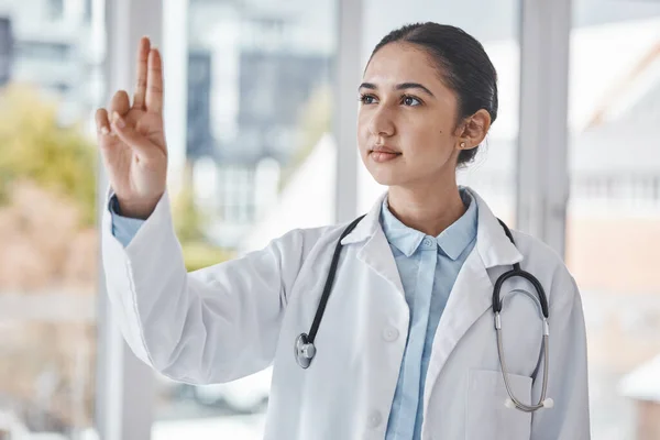 Healthcare, pointing fingers and doctor in a hospital after a wellness or health consultation. Medicare, hand and professional female medical worker standing with a gesture in a medic clinic