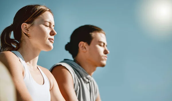 Fitness, exercise and meditation couple on blue sky mockup space for health and wellness outdoor. Man and woman in nature for workout, mental health and healthy lifestyle for body and mind in summer.