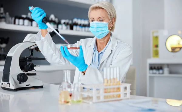 Woman, doctor and micro pipette with mask for experiment, sample or covid testing in scientific research or exam in lab. Female scientist or medical expert working with chemical in science laboratory.