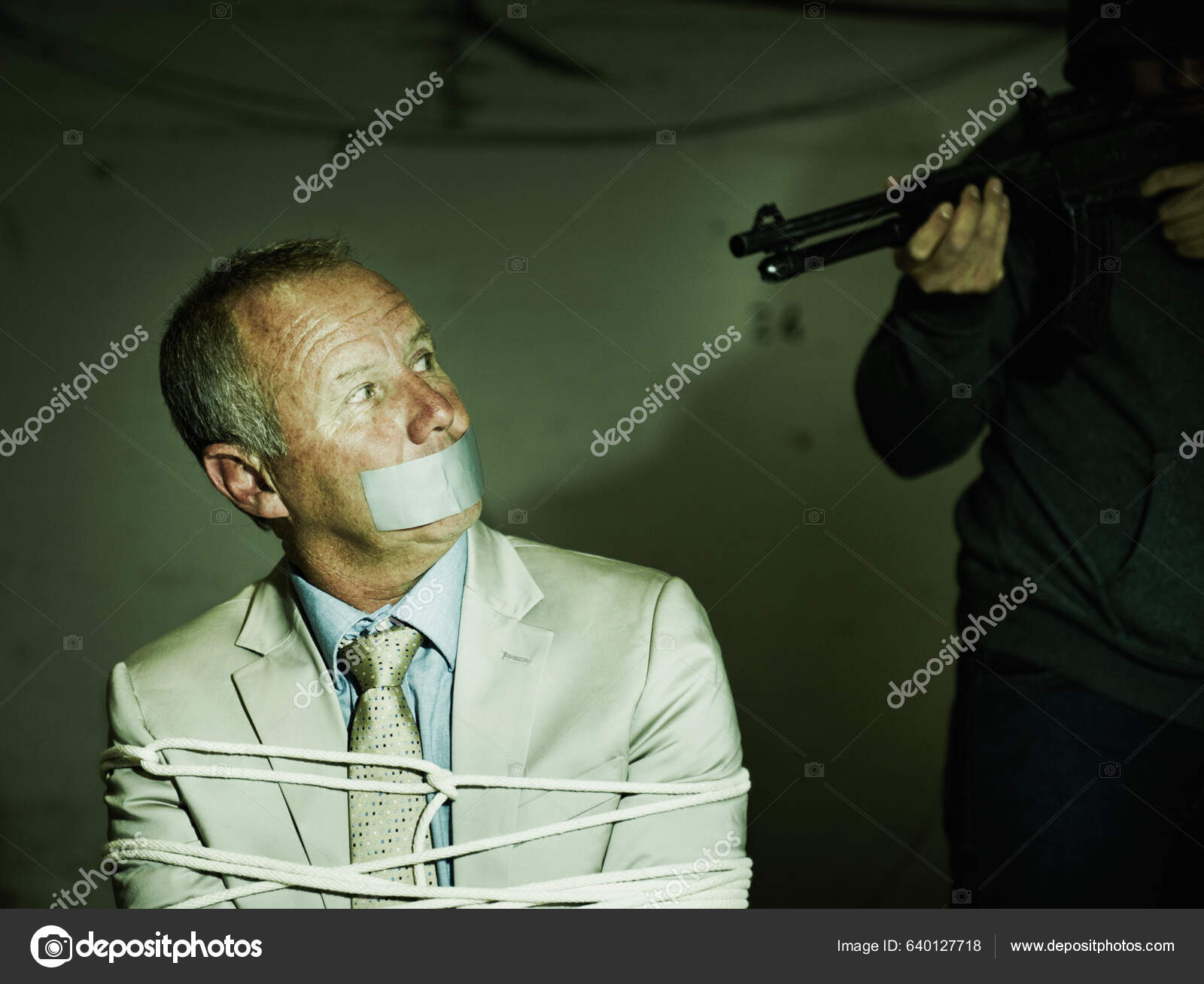 Held Gunpoint Bound Gagged Businessman Staring Barrel His Assailants Rifle  Stock Photo by ©PeopleImages.com 640127718