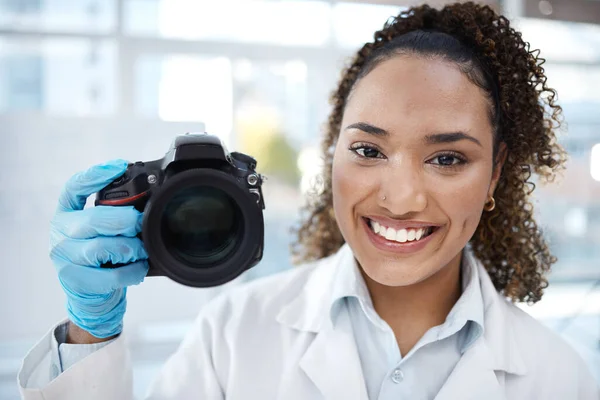 Camera, photography and portrait of black woman in forensics laboratory for investigation, crime scene and evidence. Research, analytics and observation with girl and digital pictures for science.