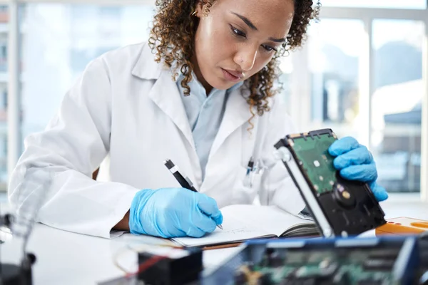 Black woman technician, computer or laptop circuit for cyber crime investigation, analysis and IT solution. Information technology engineer, notebook and laboratory for programming, writing and notes.
