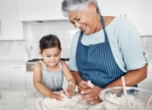 Love, grandmother and girl baking, learning and happiness on weekend, break and teaching skills. Female kid, old woman or granny with granddaughter in kitchen, dough or bonding with child development.