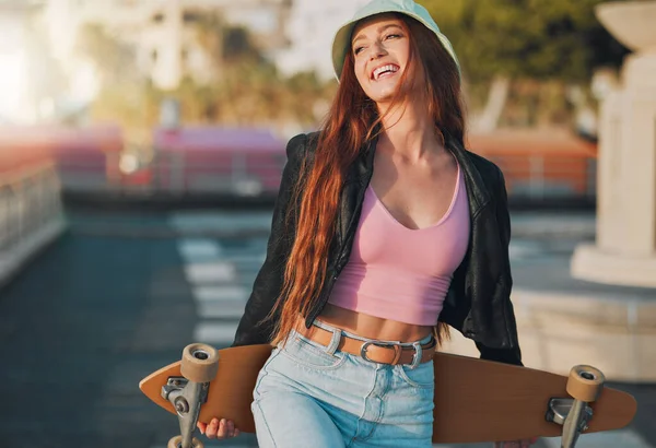 Summer, happy and skateboard with woman in city for freedom, sports and relax lifestyle. Training, fitness and sunset with girl walking in urban town enjoying adventure, wellness and energy vacation.