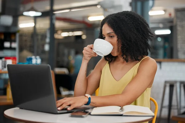Coffee, internet cafe and laptop with a black woman blogger doing research while doing remote work. Restaurant, freelance and startup with a female entrepreneur working on her small business blog.