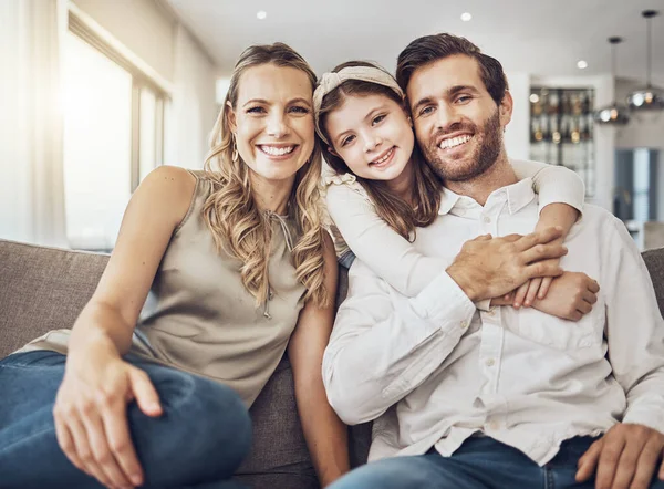 Portrait, mother or father hugging a girl to relax as a happy family in living room bonding in Australia with love or care. Trust, embrace or parents smile with kid enjoying quality time on a holiday.