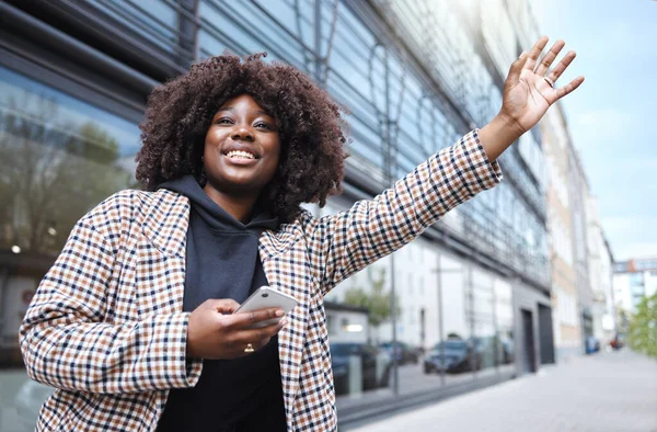 Taxi, hands and sign by black woman in city for travel, commute or waiting for transport on building background. Hand, bus and stop by girl in Florida for transportation service, app or drive request.