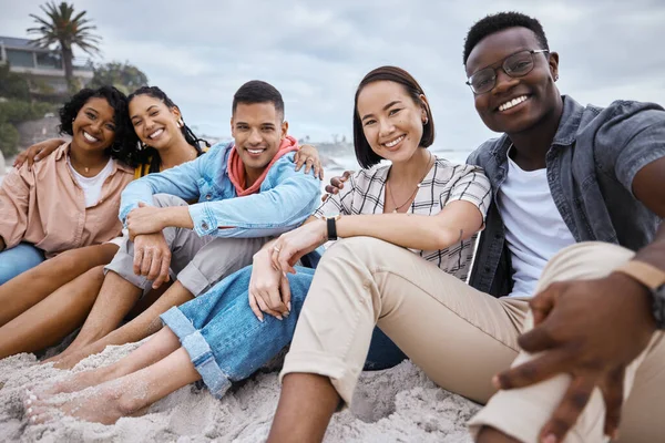 Friends, group and portrait at beach, sand and outdoor nature for fun, happiness and travel. Diversity of happy young people at sea, ocean holiday and vacation with smile of relaxing weekend together.