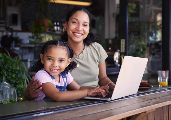 Portrait, black family in cafe and laptop for communication, weekend break and connection. Love, mother and daughter in coffee shop, search internet or website for online reading and bonding together.