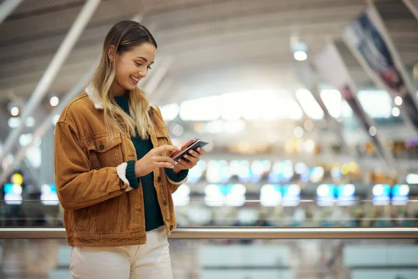 Phone, travel and woman with passport at airport lobby for.social media, internet browsing or web scrolling. Vacation, mobile technology and female with smartphone and ticket for global traveling