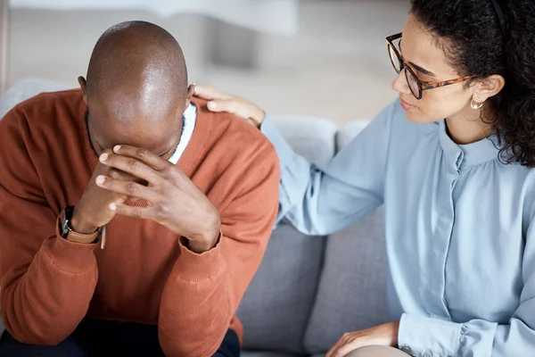 Support, therapy and woman with black man, help with grief and depression in office. Mental health, female psychologist and African American male patient with sadness, anxiety and anxious with loss.