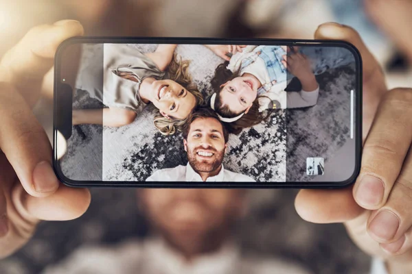 Portrait, phone or parents with a girl on a selfie screen as a happy family on living room carpet in Australia. Mother, father or child relaxing with a smile love bonding time or taking pictures.