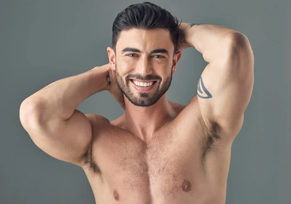 stock image I care about looking my best. a handsome young man posing against a grey background