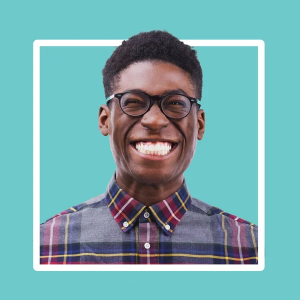 Portrait, black man and excited smile in studio with glasses on color frame, border and background. Funny face, happy male model and nerd smiling with confidence, happiness and confident young geek.