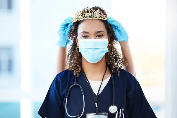 Crown, face mask and portrait of a woman nurse with an award, achievement or promotion in the hospital. Success, healthcare and female doctor with tiara for celebration, motivation or gift in clinic