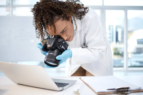 Medical investigation, camera and black woman with laptop in laboratory for forensic research with evidence. Photography, science and girl take picture for crime analysis, analytics and observation.