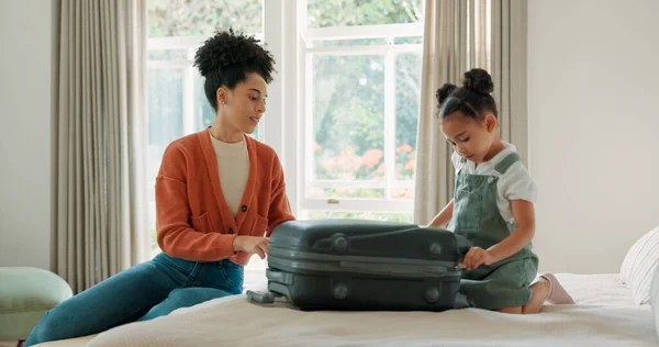 Travel, luggage and mom packing with child in bedroom getting ready for trip. Helping hands, black family and young girl help mother pack clothes in suitcase for holiday, vacation and weekend away.