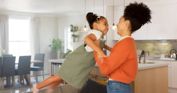 Mother and daughter dancing, celebration and doing fun dance moving to love song in apartment with happy sisters, nanny or home mom. Woman, child care and black family for radio happiness energy time.