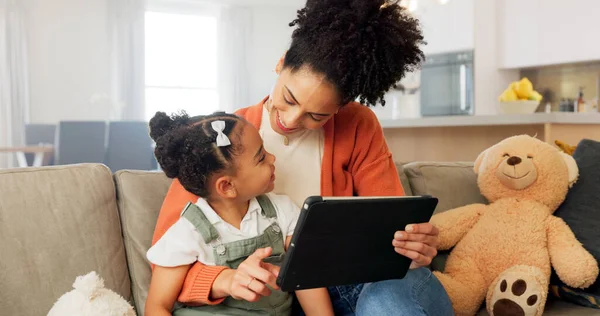 Tablet, learning and black family on education app in home for remote teaching with happy child. Living room, teacher and smile of mother helping daughter with educational internet application