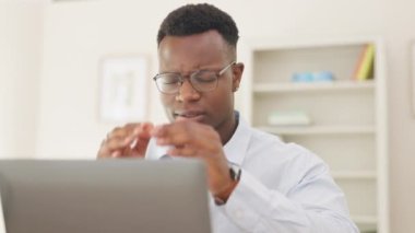 Stress, headache and professional black man in the office with a project or work deadline. Migraine, frustration and African male business employee with burnout while working on computer in workplace.