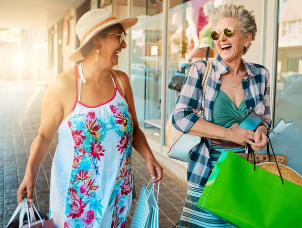 Friends, shopping and senior women outdoor, summer vacation or journey for adventure with happiness. Mature females, happy elderly ladies or purchase clothes with smile, retirement or holiday reunion.