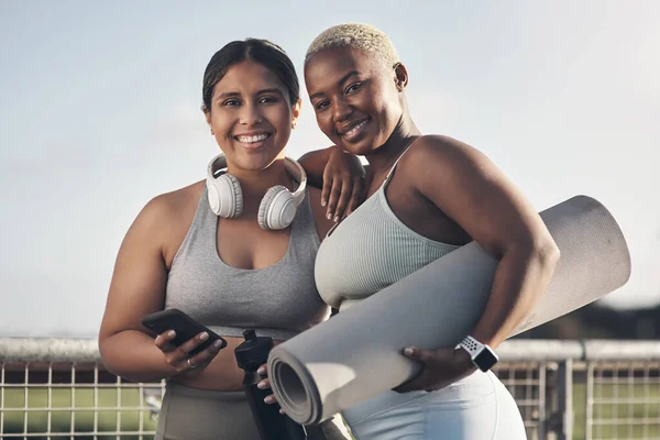 Its just us and our online fitness coach. Portrait of two friends out for a workout together