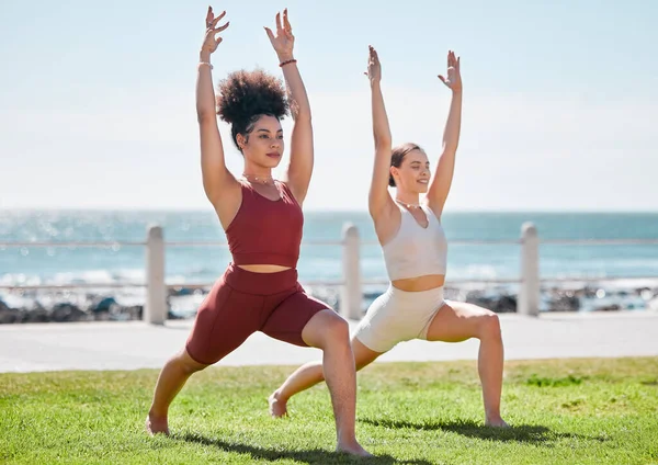 Yoga, fitness and beach with woman friends outdoor together in nature for wellness training. Exercise, chakra or zen with a female yogi and friend outside for a mental health workout by the ocean.