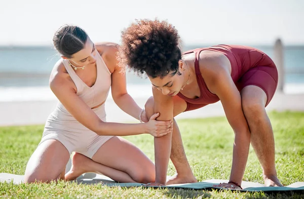 Yoga, personal trainer or women support, helping and learning balance, training and exercise on beach or park. Mentor with black woman or client in pilates workout on grass sports for body wellness.