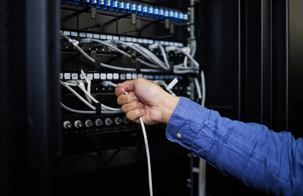 Engineer hands, server room and cable connection for software update or maintenance at night. Cybersecurity wires, cloud computing and male programmer or man check database network in data center