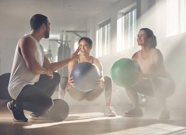 Lets get working on the lower-body. two women using fitness balls while working out with their trainer