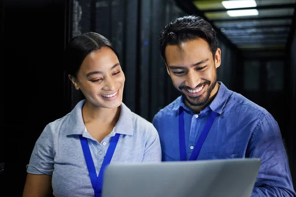 People, happy or laptop in server room, IT engineering or software programming for cybersecurity, analytics or database safety. Smile, man or data center woman on technology in teamwork collaboration.