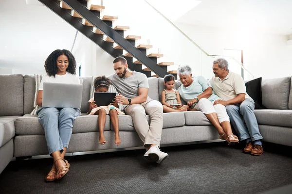 Family addicted to technology devices, social media and the internet in a home or house connected to wifi. Online, laptop and tablet by distracted people, grandparents and children with parents.