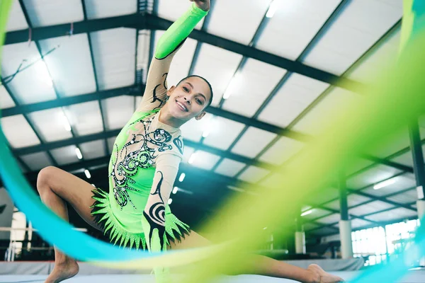 Woman, gymnastics and ribbon portrait in performance training, creative exercise or fitness practice for dynamic art. Smile, happy and rhythmic gymnast, athlete or equipment in dance sports workout.