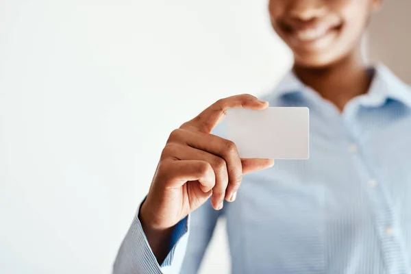Take my details, lets do business. an unrecognizable woman holding a blank business card