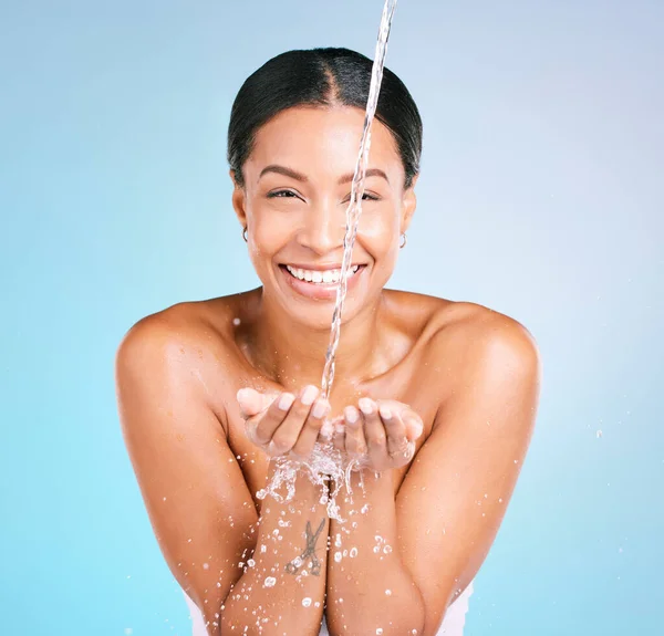 Portrait, water and black woman with smile, skincare and dermatology on blue studio background. Face, African female and lady with happiness, aqua and clear liquid for washing, cleaning and mockup.