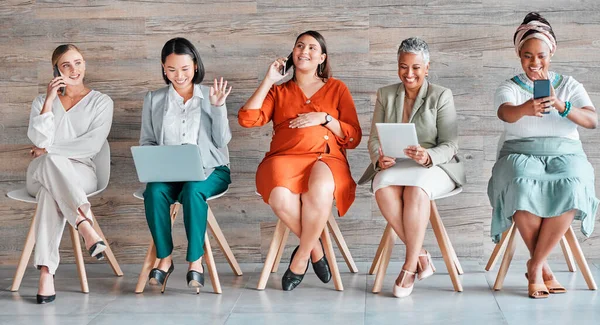 Diversity, women and waiting with devices, happiness and business with confidence, recruitment and job interview. Multiracial, female employees and staff with teamwork, digital connection and typing.
