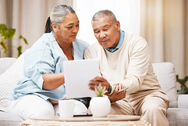 Finance documents, sofa and senior couple with paperwork for taxes, mortgage payment and savings. Home insurance, banking and elderly man and woman with banking form for loan, investment and pension.