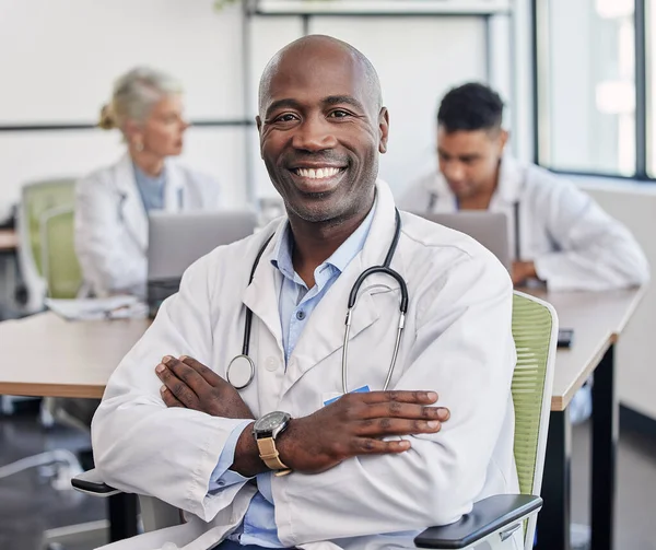Arms crossed, portrait and a black man in healthcare workshop with vision and motivation. Happy, medicine and an expert African doctor in medical meeting, seminar or conference at a hospital.